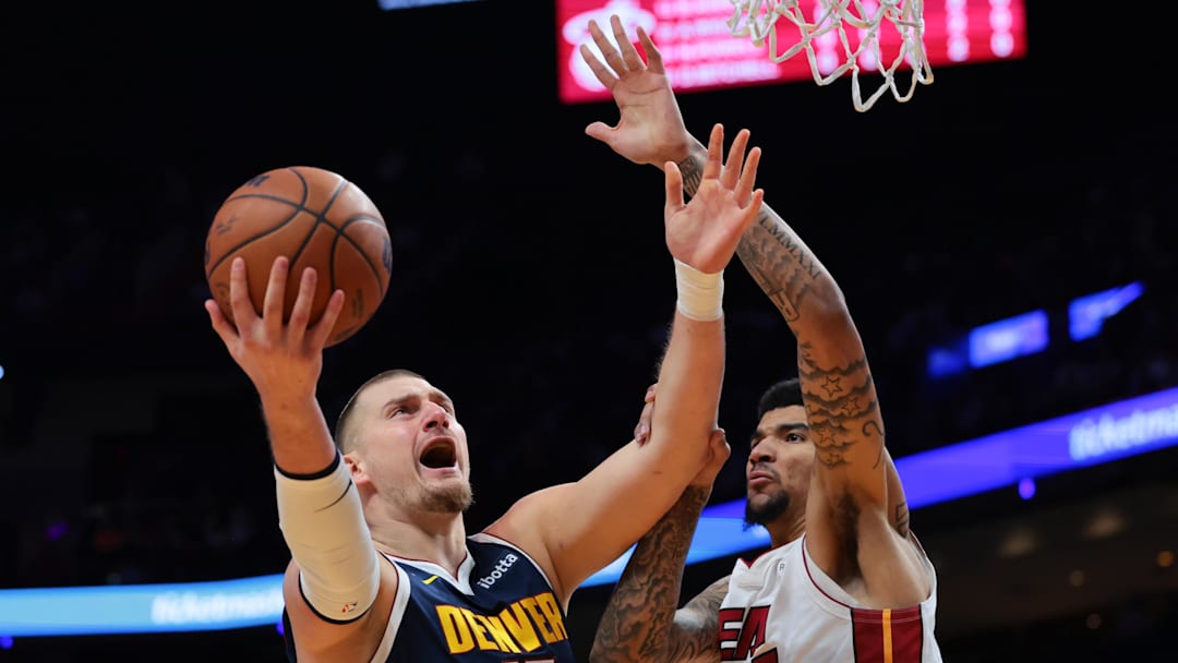 Dec 29, 2025; Miami, Florida, USA; Denver Nuggets center Nikola Jokic (15) drives to the basket against Miami Heat center Kel'El Ware (7) during the first quarter at Kaseya Center. Mandatory Credit: Sam Navarro-Imagn Images