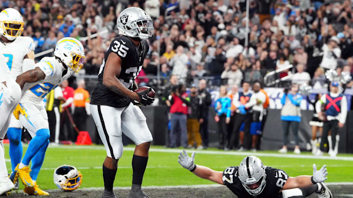 Dec 14, 2023; Paradise, Nevada, USA; Las Vegas Raiders running back Zamir White (35) celebrates after scoring a touchdown against the Los Angeles Chargers in the first quarter at Allegiant Stadium. Mandatory Credit: Stephen R. Sylvanie-Imagn Images