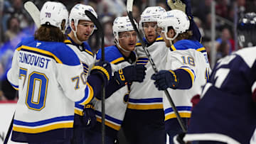 Mar 29, 2025; Denver, Colorado, USA; St. Louis Blues center Zack Bolduc (76) (center) celebrates his goal with defenseman Cam Fowler (17),center Robert Thomas (18),center Oskar Sundqvist (70) and  left wing Pavel Buchnevich (89) in the first period against the Colorado Avalanche at Ball Arena. Mandatory Credit: Ron Chenoy-Imagn Images
