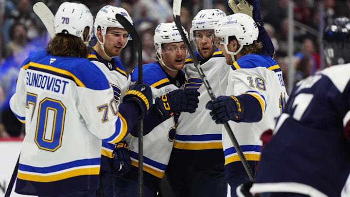 Mar 29, 2025; Denver, Colorado, USA; St. Louis Blues center Zack Bolduc (76) (center) celebrates his goal with defenseman Cam Fowler (17),center Robert Thomas (18),center Oskar Sundqvist (70) and  left wing Pavel Buchnevich (89) in the first period against the Colorado Avalanche at Ball Arena. Mandatory Credit: Ron Chenoy-Imagn Images