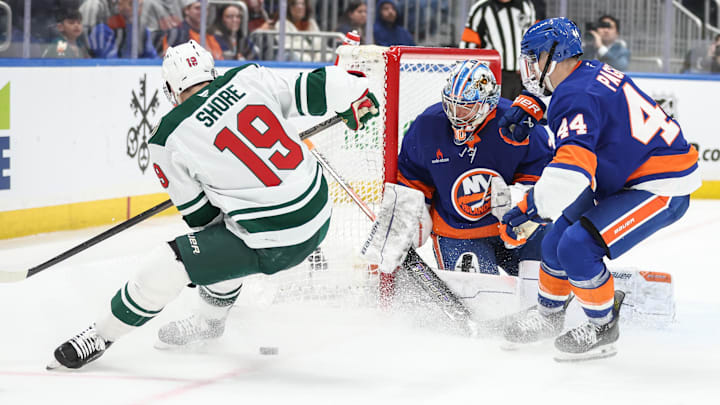 Apr 4, 2025; Elmont, New York, USA;  New York Islanders goaltender Ilya Sorokin (30) defends the net against a shot on goal attempt by Minnesota Wild center Devin Shore (19) in the third period at UBS Arena. Mandatory Credit: Wendell Cruz-Imagn Images