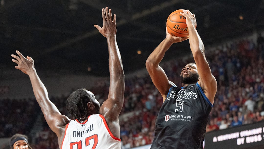 La Familia's Andrew Harrison (5) goes for a jump shot against The Ville's Chinanu Onuaku (32) during their game on Monday, July 29, 2024 at Freedom Hall in Louisville, Ky. during the quarter finals of The Basketball Tournament.