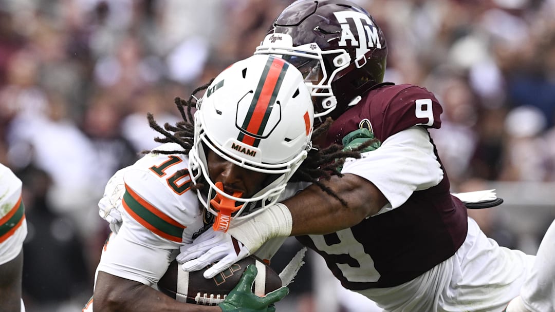 Dec 20, 2025; College Station, TX, USA; Miami Hurricanes wide receiver Malachi Toney (10) is tackled by Texas A&M Aggies defensive end Cashius Howell (9) during the second half of the first round game of the CFP National Playoff at Kyle Field. Mandatory Credit: Jerome Miron-Imagn Images