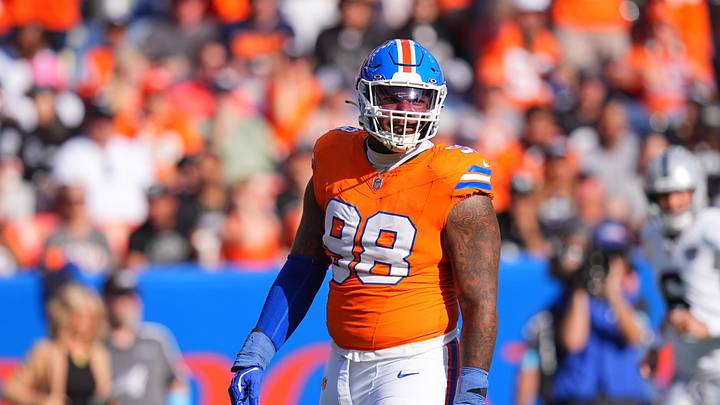 Oct 6, 2024; Denver, Colorado, USA; Denver Broncos defensive end John Franklin-Myers (98) reacts to a defensive stop in the second half against the Las Vegas Raiders at Empower Field at Mile High. Mandatory Credit: Ron Chenoy-Imagn Images