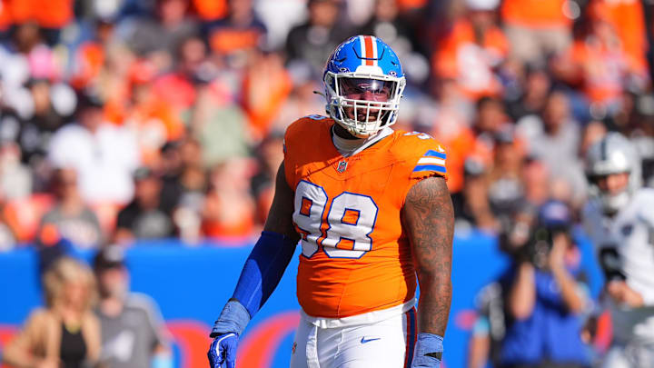 Oct 6, 2024; Denver, Colorado, USA; Denver Broncos defensive end John Franklin-Myers (98) reacts to a defensive stop in the second half against the Las Vegas Raiders at Empower Field at Mile High. Mandatory Credit: Ron Chenoy-Imagn Images