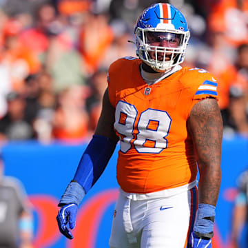 Oct 6, 2024; Denver, Colorado, USA; Denver Broncos defensive end John Franklin-Myers (98) reacts to a defensive stop in the second half against the Las Vegas Raiders at Empower Field at Mile High. 