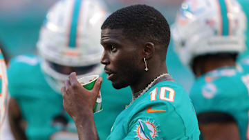 Aug 23, 2025; Miami Gardens, Florida, USA; Miami Dolphins wide receiver Tyreek Hill (10) watches from the sideline against the Jacksonville Jaguars during the first quarter at Hard Rock Stadium. Mandatory Credit: Sam Navarro-Imagn Images