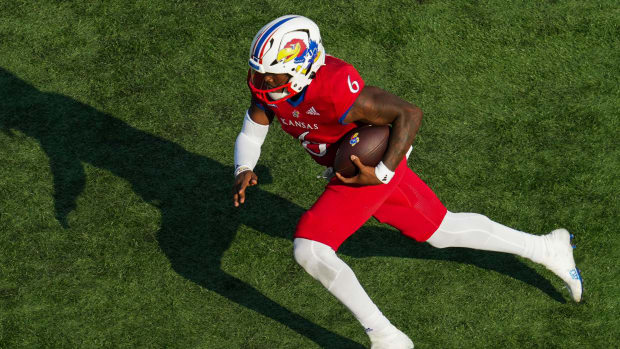 Kansas Jayhawks quarterback Jalon Daniels on a rushing attempt during a college football game in the Big 12.