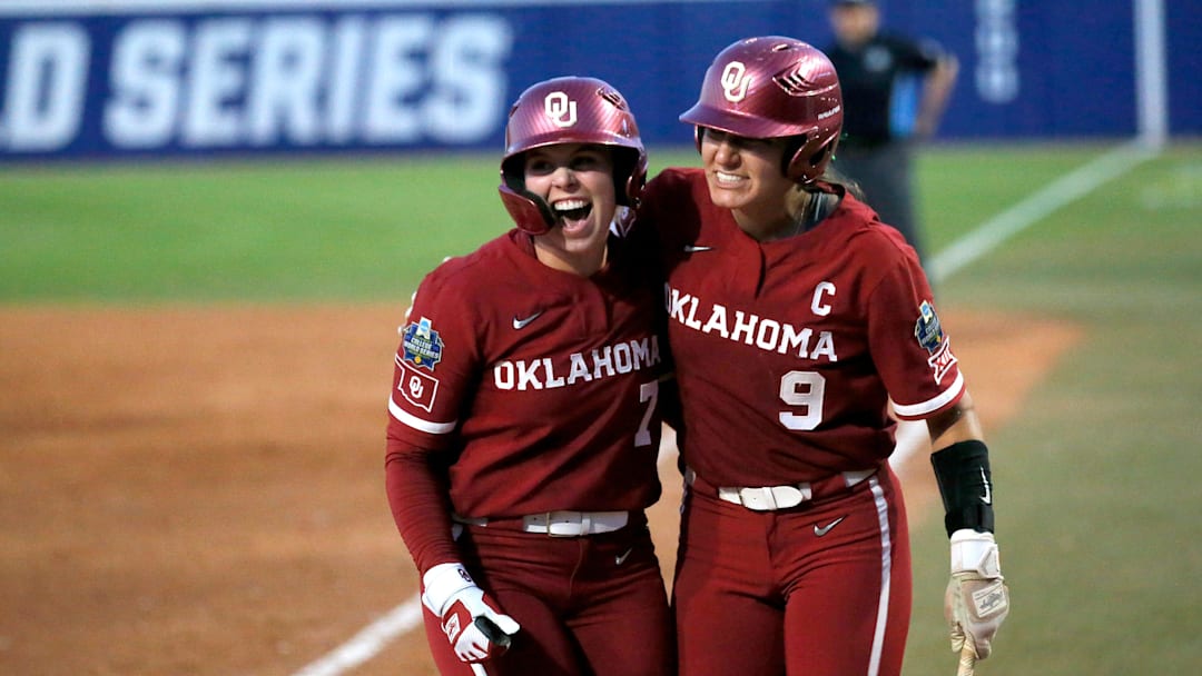 Oklahoma outfielder Kasidi Pickering (7) and catcher Kinzie Hansen (9) celebrate a score in the fourth inning during Game 2 of the NCAA softball Women's College World Series Championship Series game between the Oklahoma Sooners (OU) and Texas Longhorns at Devon Park in Oklahoma City, Thursday, June, 6, 2024.