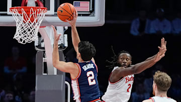 Illinois Fighting Illini guard Andrej Stojakovic (2) shoots over Ohio State Buckeyes guard Bruce Thornton (2) during the first half of the NCAA men's basketball game in Columbus on Dec. 9, 2025. Ohio State lost 86-78.
