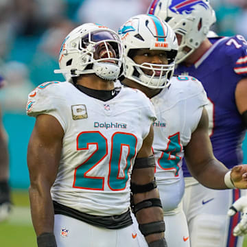 Miami Dolphins linebacker Jordyn Brooks (20) and defensive tackle Jordan Phillips (94) celebrate a fourth down stop against the Buffalo Bills during the fourth quarter at Hard Rock Stadium. Mandatory Credit: Jeff Romance-Imagn Images