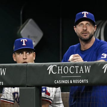 Jun 3, 2024; Arlington, Texas, USA; Texas Rangers starting pitcher Max Scherzer (31) watches from the dugout during the sixth inning against the Detroit Tigers at Globe Life Field.