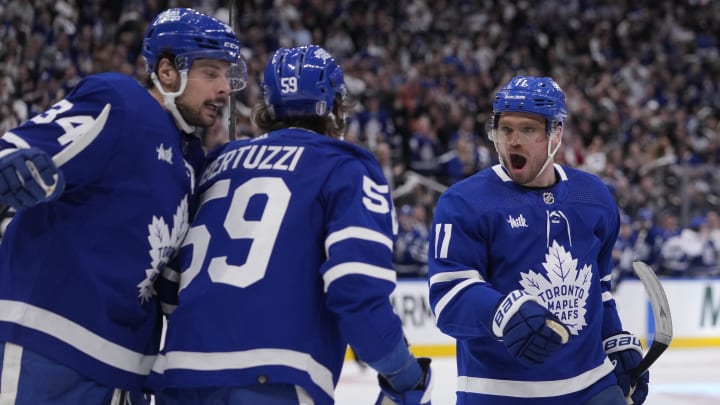 Apr 24, 2024; Toronto, Ontario, CAN; Toronto Maple Leafs forward Auston Matthews (34) and forward Max Domi (11) congratulate forward Tyler Bertuzzi (59) on his goal against the Boston Bruins during the third period of game three of the first round of the 2024 Stanley Cup Playoffs at Scotiabank Arena. Mandatory Credit: John E. Sokolowski-USA TODAY Sports