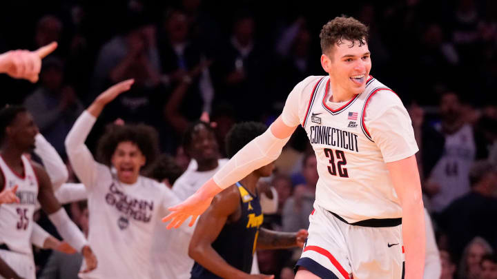 Mar 16, 2024; New York City, NY, USA;  Connecticut Huskies center Donovan Clingan (32) celebrates as the clock winds down on Marquette Golden Eagles in the second half at Madison Square Garden. Mandatory Credit: Robert Deutsch-USA TODAY Sports