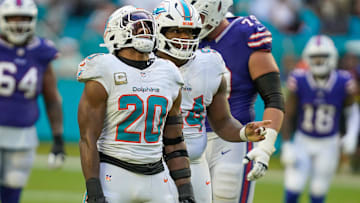 Miami Dolphins linebacker Jordyn Brooks (20) and defensive tackle Jordan Phillips (94) celebrate a fourth down stop against the Buffalo Bills during the fourth quarter at Hard Rock Stadium.