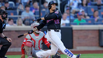 Jul 18, 2025; New York City, New York, USA; New York Mets right fielder Juan Soto (22) follows through on a solo home run against the Cincinnati Reds during the first inning at Citi Field. Mandatory Credit: Brad Penner-Imagn Images