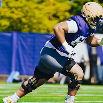Soane Faasolo heads upfield during UW spring ball.