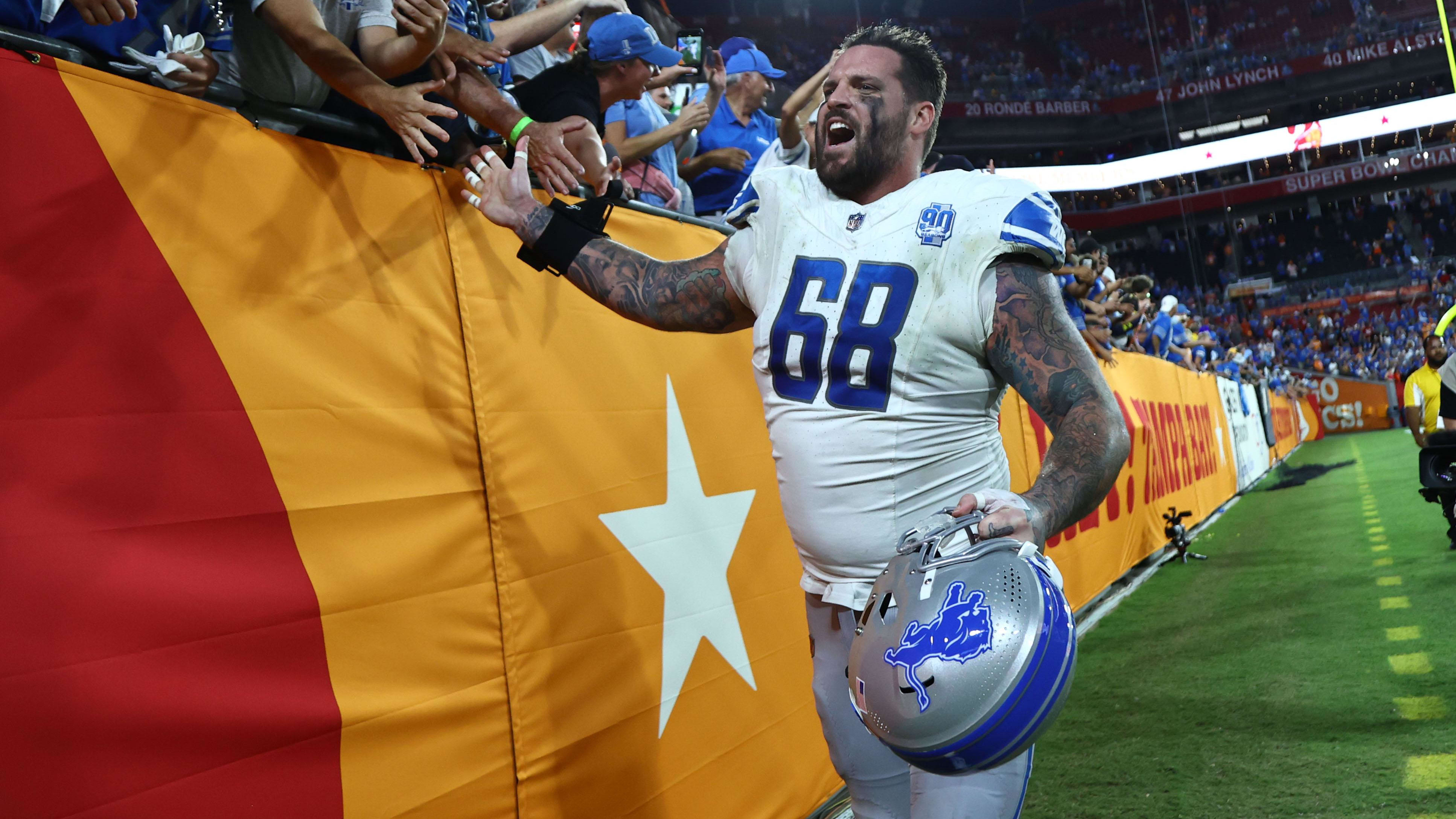 Detroit Lions offensive tackle Taylor Decker (68) celebrates with fans after beating the Tampa Bay Buccaneers.