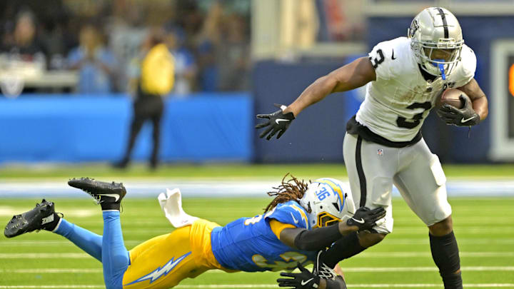 Sep 8, 2024; Inglewood, California, USA; Las Vegas Raiders running back Zamir White (3) is stopped by Los Angeles Chargers cornerback Ja'Sir Taylor (36) after a short gain in the second half at SoFi Stadium. Mandatory Credit: Jayne Kamin-Oncea-Imagn Images