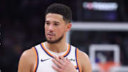 Oct 27, 2025; Salt Lake City, Utah, USA; Phoenix Suns guard Devin Booker (1) speaks with referee Scott Twardoski (52) during the fourth quarter of a game against the Utah Jazz at Delta Center. Mandatory Credit: Rob Gray-Imagn Images