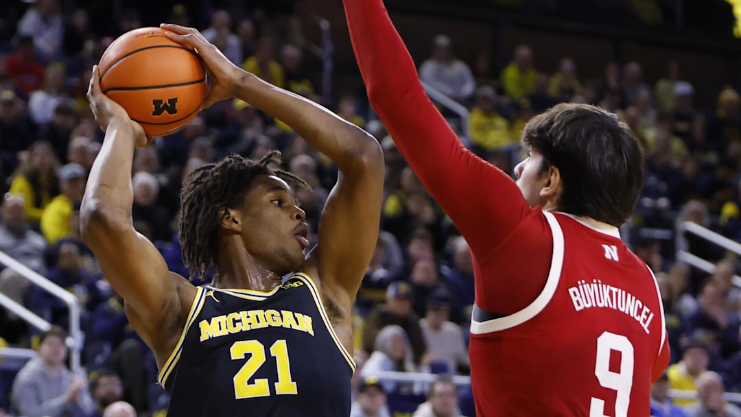 Michigan forward Morez Johnson Jr. is defended by Nebraska forward Berke Büyüktuncel.