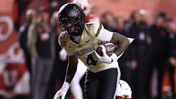 Oct 25, 2025; Salt Lake City, Utah, USA; Colorado Buffaloes wide receiver Omarion Miller (4) is tackled by Utah Utes defensive back JC Hart (14) during the second half at Rice-Eccles Stadium. Mandatory Credit: Rob Gray-Imagn Images