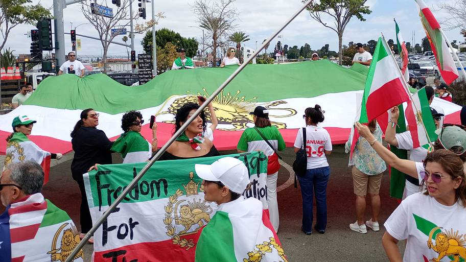 A giant Iran flag with the sun and lion insignia.