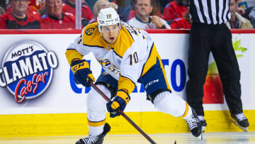 Apr 10, 2023; Calgary, Alberta, CAN; Nashville Predators left wing Egor Afanasyev (70) controls the puck against the Calgary Flames during the first period at Scotiabank Saddledome. Mandatory Credit: Sergei Belski-USA TODAY Sports