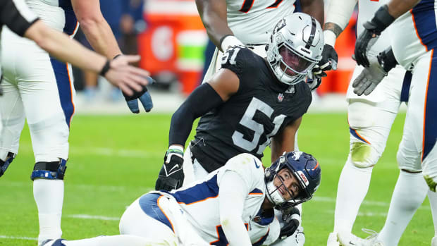 Denver Broncos quarterback Jarrett Stidham reacts after being knocked down by Las Vegas Raiders defensive end Malcolm Koonce.