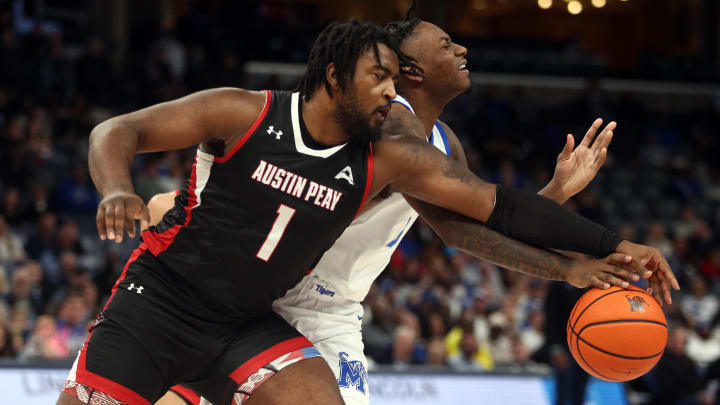 Dec 30, 2023; Memphis, Tennessee, USA; Austin Peay Governors forward Sai Witt (1) and Memphis Tigers guard Jaykwon Walton (10) battle for a loose ball during the first half at FedExForum. Mandatory Credit: Petre Thomas-USA TODAY Sports