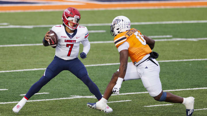 Nov 25, 2023; El Paso, Texas, USA; No. 22 Liberty Flames quarterback Kaidon Salter (7) tries to evade a UTEP Miners defensive end Maurice Westmoreland (0) during the first half at Sun Bowl Stadium. Mandatory Credit: Ivan Pierre Aguirre-USA TODAY Sports