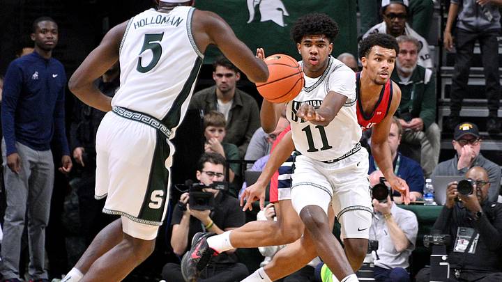 Nov 19, 2024; East Lansing, Michigan, USA; Michigan State Spartans guard Jase Richardson (11) passes to  guard Tre Holloman (5) during the first half against the Samford Bulldogs at Jack Breslin Student Events Center. Mandatory Credit: Dale Young-Imagn Images