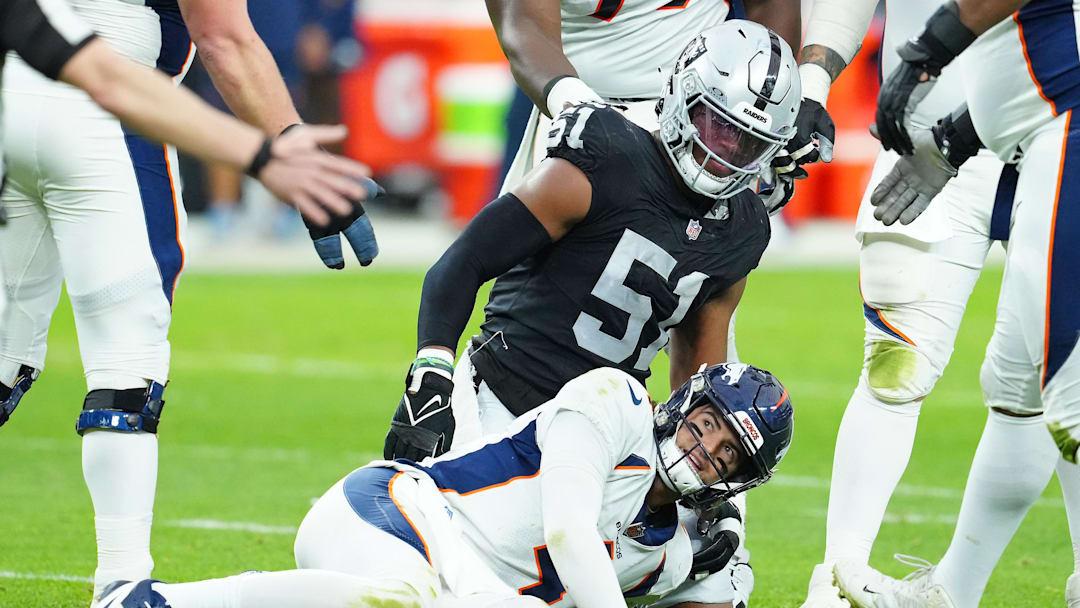Jan 7, 2024; Paradise, Nevada, USA; Denver Broncos quarterback Jarrett Stidham (4) reacts after being knocked down by Las Vegas Raiders defensive end Malcolm Koonce (51) during the second quarter at Allegiant Stadium. Mandatory Credit: Stephen R. Sylvanie-Imagn Images
