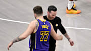 Apr 9, 2025; Dallas, Texas, USA; Los Angeles Lakers head coach JJ Redick and guard Luka Doncic (77) during the game between the Dallas Mavericks and the Los Angeles Lakers at American Airlines Center. Mandatory Credit: Jerome Miron-Imagn Images