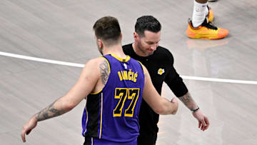 Apr 9, 2025; Dallas, Texas, USA; Los Angeles Lakers head coach JJ Redick and guard Luka Doncic (77) during the game between the Dallas Mavericks and the Los Angeles Lakers at American Airlines Center. Mandatory Credit: Jerome Miron-Imagn Images
