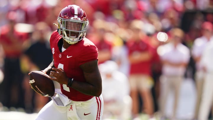 Sep 23, 2023; Tuscaloosa, Alabama, USA; Alabama Crimson Tide quarterback Jalen Milroe (4) rolls out of the pocket against the Mississippi Rebels during the first quarter at Bryant-Denny Stadium.