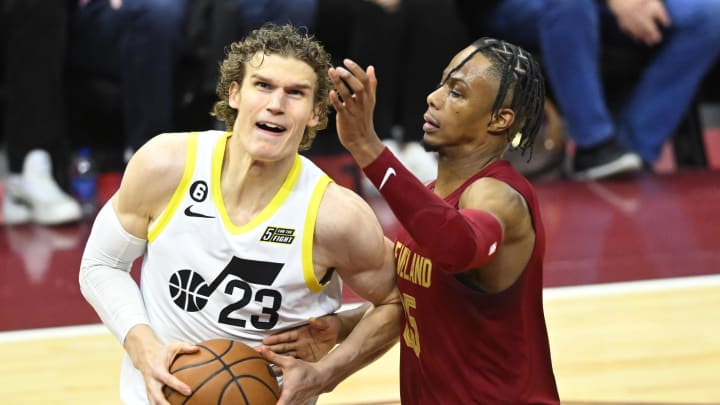 Dec 19, 2022; Cleveland, Ohio, USA; Utah Jazz forward Lauri Markkanen (23) drives against Cleveland Cavaliers forward Isaac Okoro (35) in the third quarter at Rocket Mortgage FieldHouse. Mandatory Credit: David Richard-USA TODAY Sports