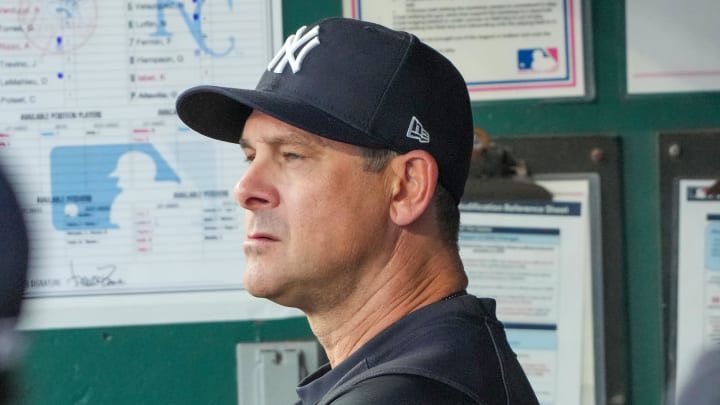 Jun 12, 2024; Kansas City, Missouri, USA; New York Yankees manager Aaron Boone (17) watches play from the dugout against the Kansas City Royals in the sixth inning at Kauffman Stadium. Mandatory Credit: Denny Medley-USA TODAY Sports