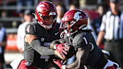 Sep 20, 2025; Pullman, Washington, USA; Washington State Cougars running back Angel Johnson (1) takes the hand off from Washington State Cougars quarterback Zevi Eckhaus (4)  in the first half of Apple Cup against the Washington Huskies at Gesa Field at Martin Stadium. Mandatory Credit: James Snook-Imagn Images