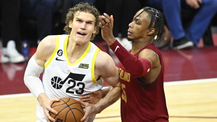 Dec 19, 2022; Cleveland, Ohio, USA; Utah Jazz forward Lauri Markkanen (23) drives against Cleveland Cavaliers forward Isaac Okoro (35) in the third quarter at Rocket Mortgage FieldHouse. Mandatory Credit: David Richard-USA TODAY Sports