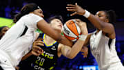 Jul 27, 2025; Arlington, Texas, USA;  Dallas Wings center Li Yueru (28) is fouled by Las Vegas Aces forward NaLyssa Smith (3) during the second half at College Park Center. 