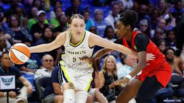 Jun 24, 2025; Arlington, Texas, USA; Dallas Wings guard Paige Bueckers (5) controls the ball as Atlanta Dream guard Maya Caldwell (33) defends during the first half at College Park Center. Mandatory Credit: Chris Jones-Imagn Images