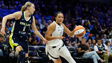 Jul 16, 2025; Arlington, Texas, USA;  Las Vegas Aces guard Aaliyah Nye (13) drives to the basket as Dallas Wings guard Paige Bueckers (5) defends during the first half at College Park Center. Mandatory Credit: Chris Jones-Imagn Images