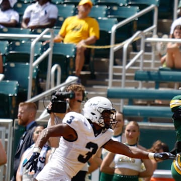 Sep 13, 2025; Waco, Texas, USA;  Baylor Bears wide receiver Louis Brown IV (4) catches a touchdown pass ahead of Samford Bulldogs cornerback Caidan Maddux (3) during the second half at McLane Stadium. Mandatory Credit: Chris Jones-Imagn Images
