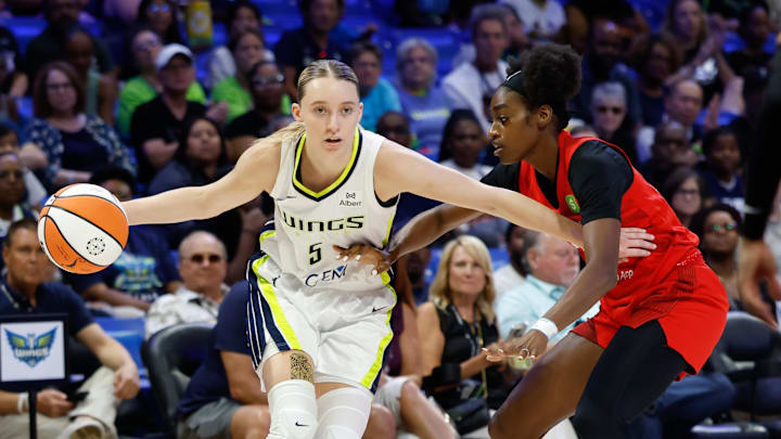 Jun 24, 2025; Arlington, Texas, USA; Dallas Wings guard Paige Bueckers (5) controls the ball as Atlanta Dream guard Maya Caldwell (33) defends during the first half at College Park Center. Mandatory Credit: Chris Jones-Imagn Images