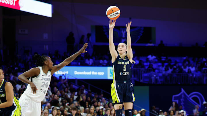 Dallas Wings guard Paige Bueckers scores a three-point basket against Las Vegas Aces guard Jewell Loyd.