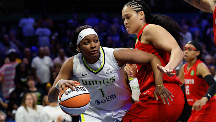 Dallas Wings forward NaLyssa Smith looks to pass against Atlanta Dream forward Brionna Jones.