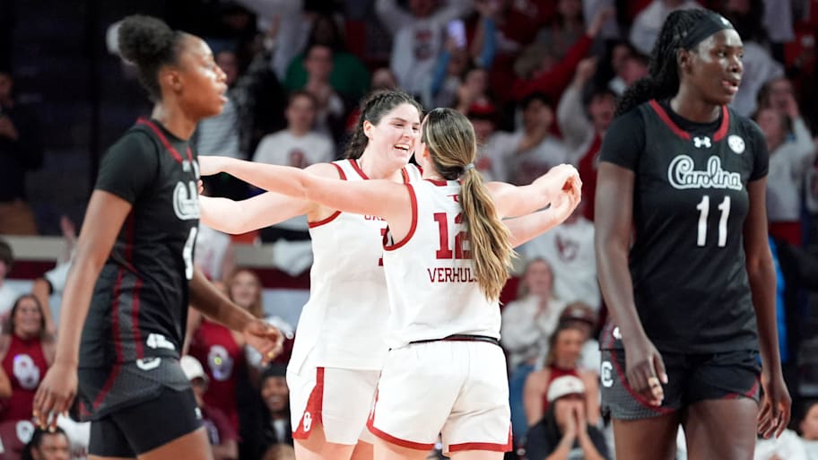 Oklahoma's Payton Verhulst (12) celebrates with Raegan Beers (15) 