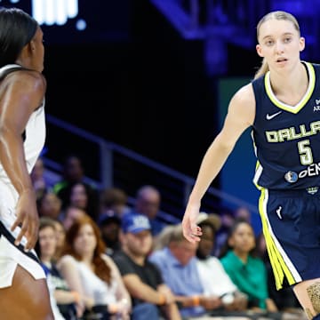 Jul 16, 2025; Arlington, Texas, USA; Dallas Wings guard Paige Bueckers (5) controls the ball against Las Vegas Aces guard Jackie Young (0) during the second half at College Park Center. Mandatory Credit: Chris Jones-Imagn Images