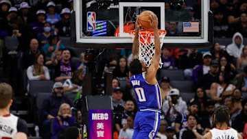 Feb 26, 2024; Sacramento, California, USA; Sacramento Kings guard Malik Monk (0) dunks the ball against Miami Heat forward Haywood Highsmith (24) during the second quarter at Golden 1 Center. Mandatory Credit: Sergio Estrada-Imagn Images